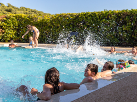 Children playing and splashing in the pool at Campsite Les Tamaris, Provence-Alpes-Côte d’Azur, France.