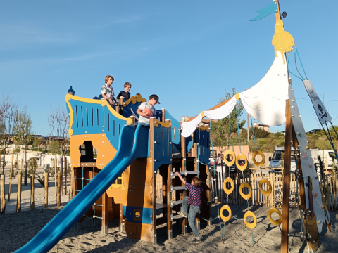 Children play on a large pirate ship playground at Campsite Les Tamaris in Provence-Alpes-Côte d’Azur, France.