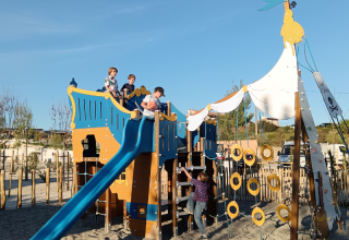 Children play on a large pirate ship playground at Campsite Les Tamaris in Provence-Alpes-Côte d’Azur, France.