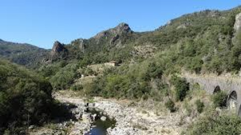 Scenic view of mountains, river and viaduct at Ushuaïa Villages Le Viaduc campsite in Auvergne-Rhône-Alpes, France.