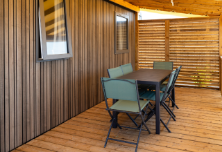 Terrazza in legno coperta con tavolo e sei sedie della Premium Mobile Home «Large Hilly location» a Les Tamaris.