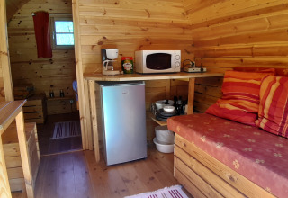 Interior of the 'Barrel' pod at Campsite Ushuaïa Villages Le Viaduc in France featuring a cozy kitchen area.