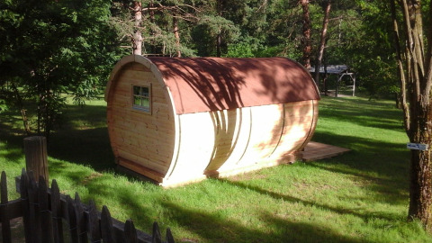 Foto van het 'Barrel'-pod bij Ushuaïa Villages Le Viaduc in Frankrijk, omgeven door groen.