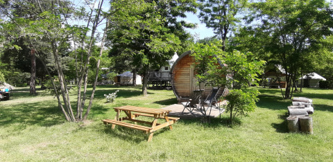 Outdoor view of the 'Barrel' pod at Campsite Ushuaïa Villages Le Viaduc in France, surrounded by trees.