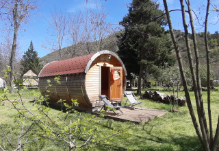 The 'Barrel' pod at Campsite Ushuaïa Villages Le Viaduc in France, set amid trees and grassy outdoors.