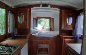 Cozy interior of the Tiny wagon cabin at Campsite Ushuaïa Villages Le Viaduc, France, with wood finish.