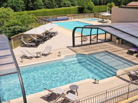 Holiday park with two swimming pools, sun loungers, and umbrellas at Campsite La Nouvelle Croze in Nouvelle-Aquitaine.