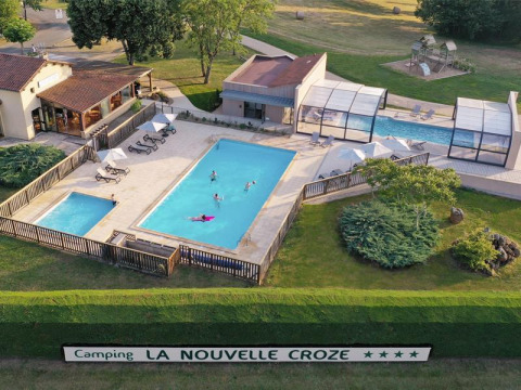 Aerial view of swimming pools and leisure area at La Nouvelle Croze campsite in Nouvelle-Aquitaine, France.
