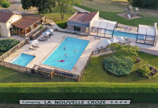 Aerial view of swimming pools and leisure area at La Nouvelle Croze campsite in Nouvelle-Aquitaine, France.