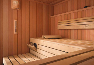 Sauna with light wooden panels and bench, pictured at La Nouvelle Croze holiday park in Nouvelle-Aquitaine, France.