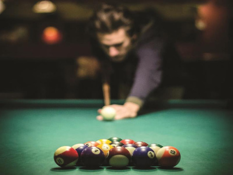 A person preparing to break in a game of billiards at La Nouvelle Croze holiday park in France.