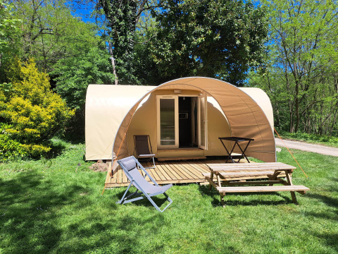 Safari tent 'Coco Sweet' at Campsite Ushuaïa Villages Le Viaduc in France, surrounded by lush greenery.