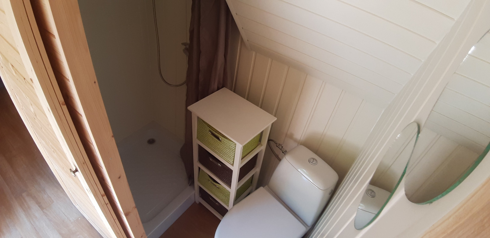 Kleine badkamer in de Magic Hut, Ushuaïa Villages Le Viaduc, Frankrijk, met douche, toilet en lades.