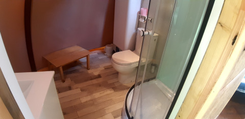 Bathroom inside Wigwam dome at Campsite Ushuaïa Villages Le Viaduc, France, featuring shower and toilet.