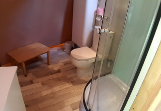 Bathroom inside Wigwam dome at Campsite Ushuaïa Villages Le Viaduc, France, featuring shower and toilet.