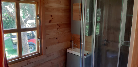 Bathroom in Ranch Chalet at Ushuaïa Villages Le Viaduc, featuring a window, small sink, and shower.