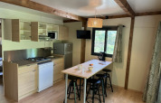 Angolo cottura moderno e zona pranzo al Cottage «Pantaïa» presso il campeggio Le Luberon in Francia.