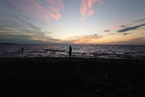 Coucher de soleil sur la mer, vu depuis la plage du logement 4 personnes à Haderslev, Danemark, avec des silhouettes.
