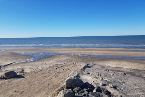 View of the beach and sea from the 7 person holiday home in Hjørring, Denmark, with a clear blue sky.