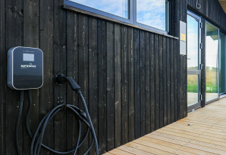 EV charging station mounted on wood wall at 7 person holiday home in Hjørring, Denmark.