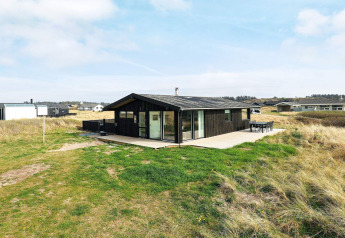 7-person holiday home in Hjørring, Denmark, with large patio and surrounded by natural grasslands.