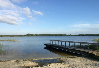 Uitzicht op het meer met houten steiger bij het 8-persoons vakantiehuis in Ansager, Denemarken.