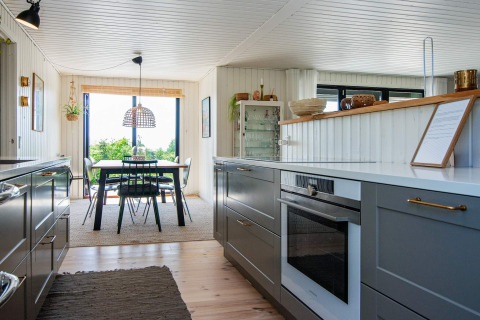 Moderne keuken en eetruimte in '8 person holiday home in Ebeltoft', Denemarken, met tuinzicht en grote ramen.