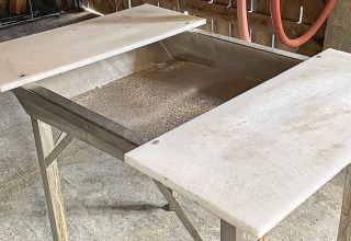 Werktafel met twee witte snijplanken en metalen bak, geplaatst in een vakantiehuis in Reksteren.
