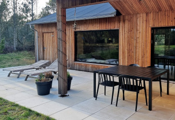 Buitenterras bij 8-persoons vakantiehuis in Ålbæk, Denemarken, met tuinmeubilair en ligstoelen.