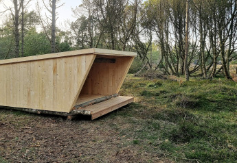 Wooden shelter in the forest near 8 person holiday home in Ålbæk, Denmark, ideal for outdoor stays.