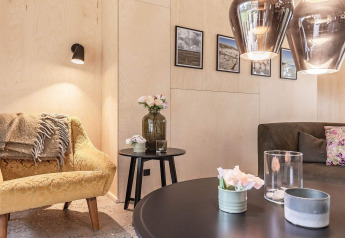 Cozy lounge in 8 person holiday home in Ålbæk, Denmark, featuring modern decor, photos, and soft lighting.