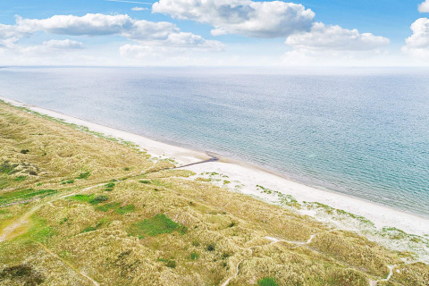 Vista costiera vicino alla casa vacanze per 8 persone ad Ålbæk, Danimarca, con spiaggia e cielo azzurro.