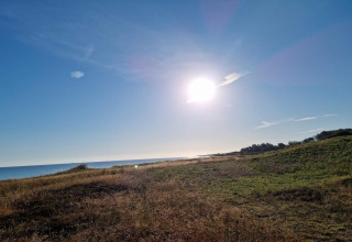 Sunny landscape view of beach and fields at Allingåbro, taken from a holiday home lodge in Denmark.