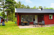 Red 6-person holiday home in Mönsterås, Sweden, with patio and garden furniture in a green setting.