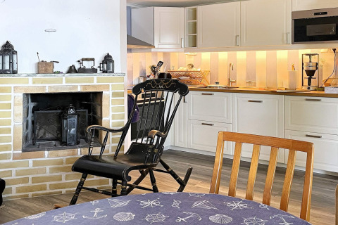 Acogedora sala y cocina en casa vacacional para 6 personas en Rimforsa, Suecia, con chimenea.