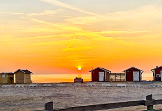 Coucher de soleil sur la côte avec cabanes près de «3 person holiday home in LÖTTORP» en Suède.