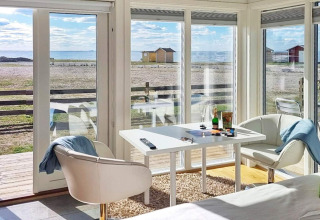 Licht vakantieverblijf in Löttorp, Zweden, met zeezicht door grote ramen en moderne inrichting.