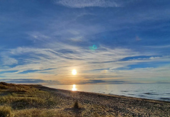 Sunset view from a 4 person holiday home in Frederiksværk, Denmark, overlooking the serene beach.