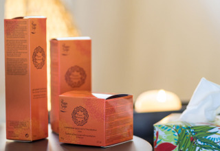 Beauty products and tissue box on a table in a glamping accommodation at Auberge et Chalets de la Wormsa.