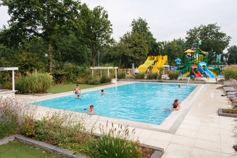 Family-friendly pool area with water slides and playground at Camping de Pallegarste, Overijssel, Netherlands.