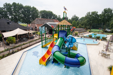 Water playground with slides and elephant decor at Camping de Pallegarste - Safaritenten Overijssel in the Netherlands.