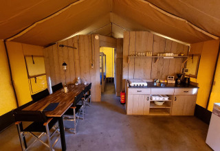 Interior de una tienda safari en Recreatiepark de Achterste Hoef con comedor y cocina en Brabant.