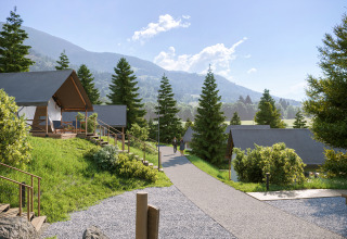 Glamping Village Kötschach - Safaritenten Karinthië avec des tentes safari de luxe dans un cadre montagneux verdoyant.