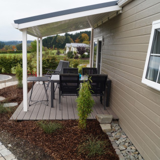 Overdekte veranda met tuinset aan een chalet op Camping en Vakantiepark Brilon in Noordrijn-Westfalen.