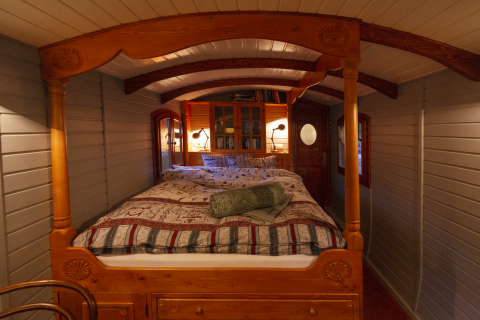 Sistemazione glamping accogliente al Park am See di Obertraun, Austria, con letto in legno e luce calda.