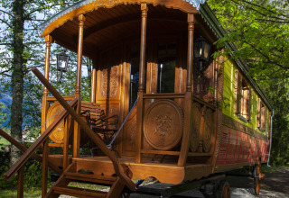 Colorful, ornate glamping wagon accommodation in Park am See, holiday home in Obertraun, Austria.