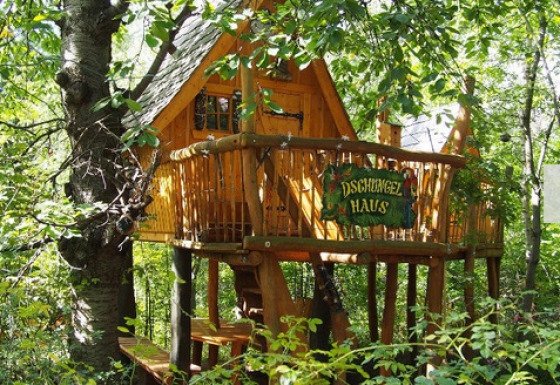 Alojamiento glamping en casa de árbol en Familiepark Sottrum, Boomhutten Nedersaksen, rodeado de bosque.