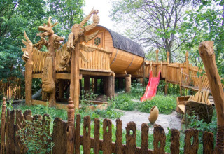 Treehouse glamping accommodation at Familiepark Sottrum, Lower Saxony, surrounded by nature and playground.