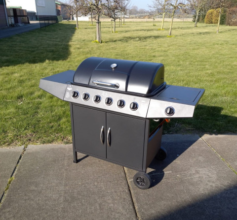 Large outdoor gas barbecue grill on a patio at Glamping Heemskerkerduin - Safaritenten Noord-Holland campsite.