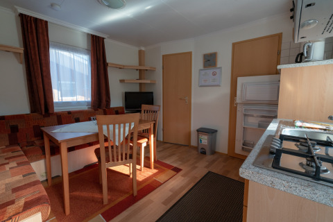 Interior view of glamping accommodation at Camping Hetzingen - Stacaravans Noordrijn-Westfalen with kitchen